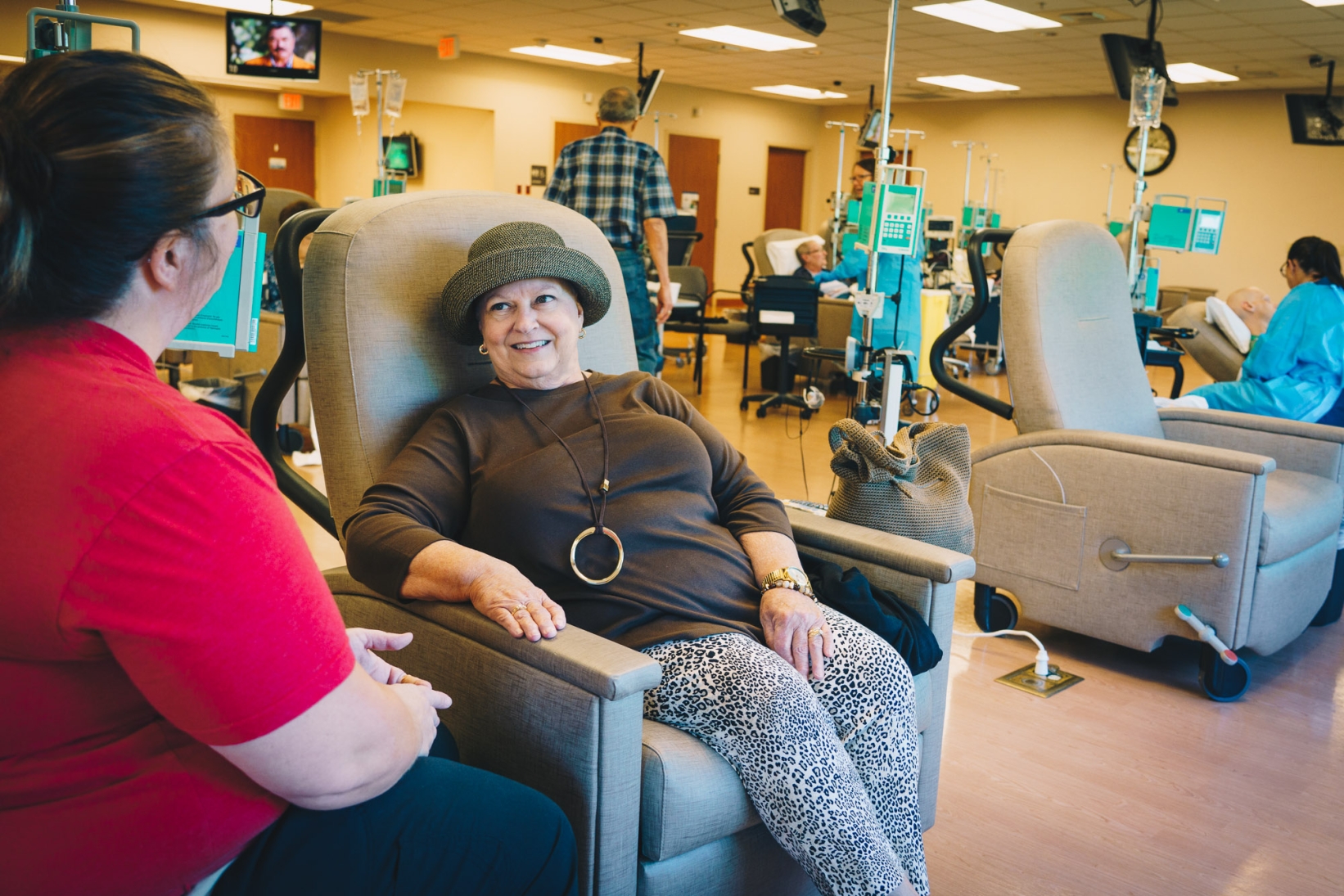 Staff talking to lady in hat